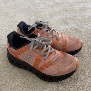 On Cloud Coral and Black Athletic Shoes